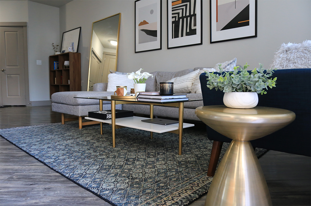 Custom patterned rug in a sitting room with a low sofa and gold side table